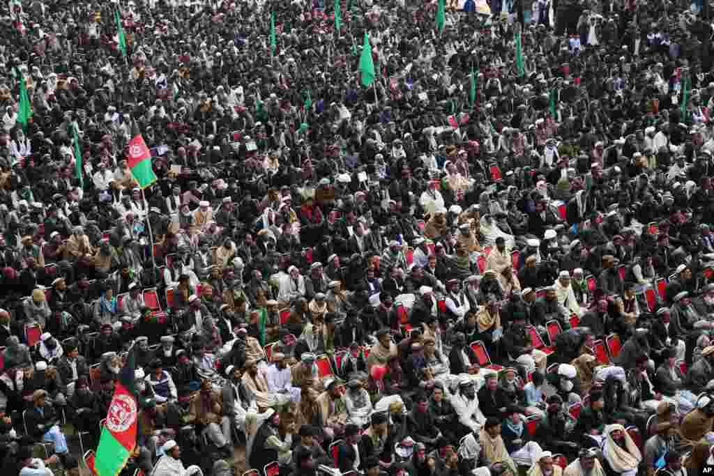 Supporters of Afghan presidential candidate Abdullah Abdullah listen to his speech during a campaign rally in Deh Sabz district on the outskirts of Kabul, March, 5, 2014.