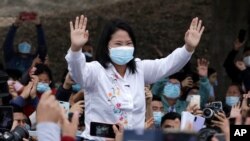 Presidential candidate Keiko Fujimori waves at supporters after casting her vote in Lima, Peru, June 6, 2021.