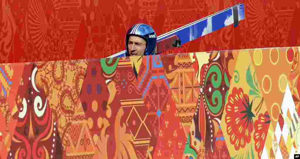 Wilhelm Denifl of Austria carries his skis during a men's nordic combined training session in the ski jumping stadium, Krasnaya Polyana, Russia, Feb. 10, 2014.