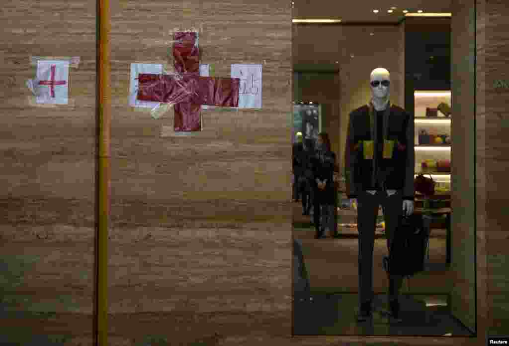 A red cross sign is seen at a first aid station set up by protesters outside a luxury shop along a main street at Hong Kong's Tsim Sha Tsui shopping district, Oct. 1, 2014.