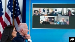 President Joe Biden and Interior Secretary Deb Haaland listen during an event in the White House complex in Washington, June 30, 2021, with cabinet officials and governors from Western states to discuss drought and wildfires.