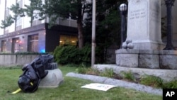 A toppled Confederate statue lies on the ground, Aug. 14, 2017, in Durham, N.C. Activists on Monday evening used a rope to pull down the monument outside a Durham courthouse. The Durham protest was in response to a white nationalist rally held in Charlottesville, Va, over the weekend. 