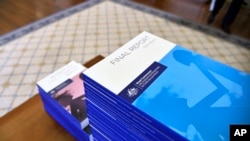 File - In this photo provided by the Australian Government Royal Commission, the volumes of the Final Report of the Royal Commission into Institutional Responses to Child Sexual Abuse sit on a table at Government House, in Canberra, Dec. 15, 2017.