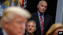 White House chief of staff John Kelly listens as President Donald Trump speaks during a meeting on tax policy with business leaders in the Roosevelt Room of the White House, Oct. 31, 2017.