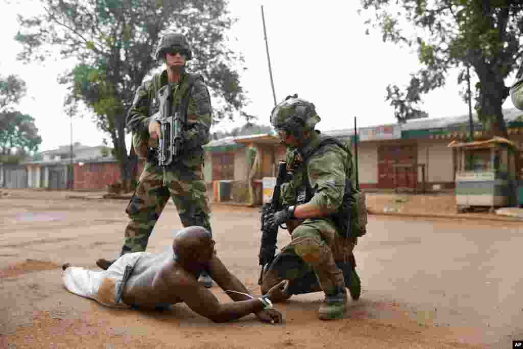French troops detain a suspected Seleka officer, preventing Christian mobs from lynching him near the airport in Bangui, Central African Republic, Dec. 9, 2013.