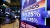 FILE - A television monitor on the floor of the New York Stock Exchange headlines a rate decision of the Federal Reserve, in New York, July 31, 2019. 