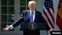 FILE - U.S. President Donald Trump gestures as he speaks during a news conference in the Rose Garden at the White House in Washington, Sept. 26, 2017.