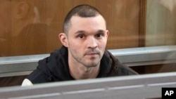 FILE - U.S. Army Staff Sgt. Gordon Black sits in a glass cage in a courtroom in Vladivostok, Russia, June 6, 2024.
