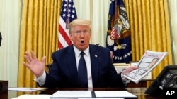 President Donald Trump speaks before signing an executive order aimed at curbing protections for social media giants, in the Oval Office of the White House, May 28, 2020.