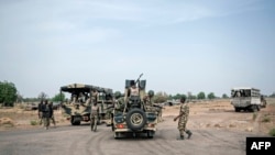 FILE - Soldiers of the 7th Division of the Nigerian Army meet at a cross road in Damboa, Borno State northeast Nigeria on March 25, 2016.