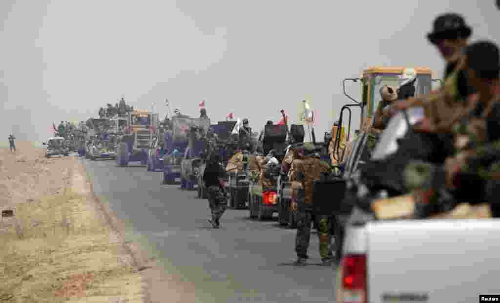 Shi'ite paramilitary forces ride military vehicles traveling from Lake Tharthar toward Ramadi to fight against Islamic state militants, west of Samarra, Iraq May 27, 2015.