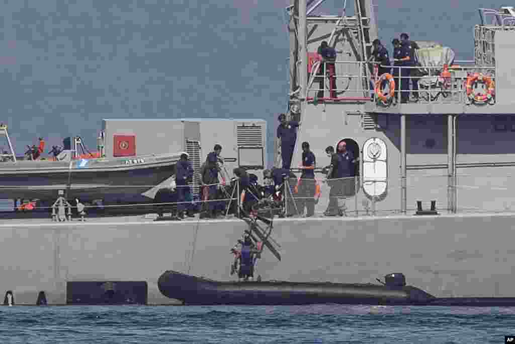 A small inflatable dinghy with a suspected smuggler on board is stopped by a Greek coast guard patrol boat, in Greece’s eastern Aegean Sea island of Lesbos.