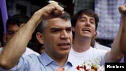 FILE - Peruvian presidential candidate Julio Guzman greets supporters during a rally at a market in the San Juan de Lurigancho district of Lima, Jan. 20, 2016.