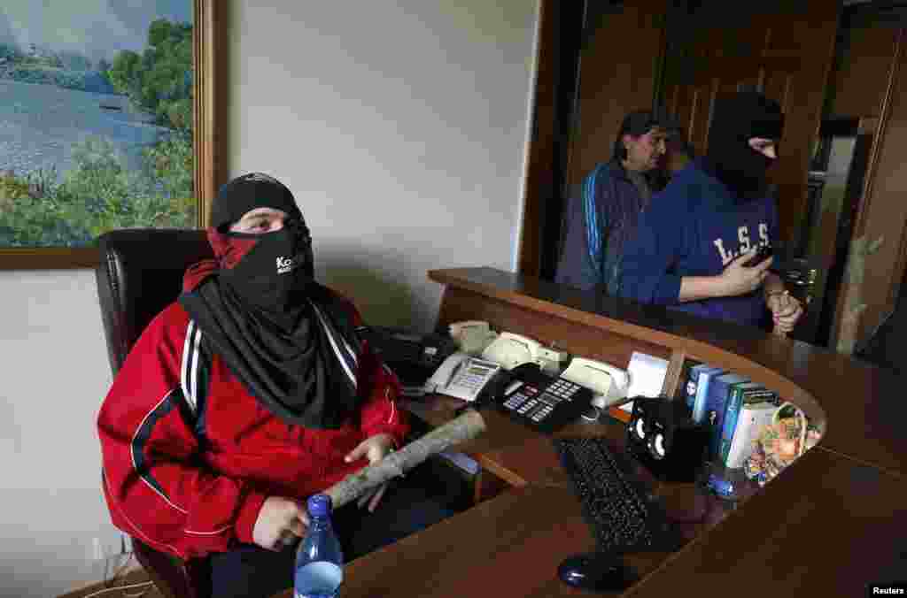Pro-Russian activists inside the regional government headquarters in Luhansk, eastern Ukraine, April 29, 2014. Hundreds of pro-Russian separatists stormed the headquarters on Tuesday, unopposed by police.