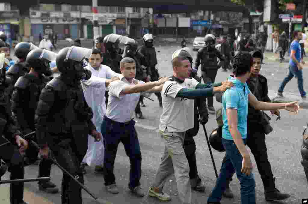 Supporters of ousted President Mohamed Morsi are detained during clashes with riot police in Cairo, Oct. 6, 2013.