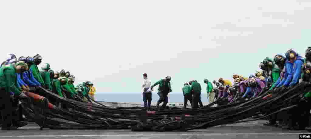 Sailors set up an emergency aircraft barricade during flight deck training drills aboard the aircraft carrier USS George H.W. Bush (CVN 77). George H.W. Bush is conducting a tailored ship's training availability and final evaluation problem in the Atlantic Ocean. (U.S. Navy photo by Mass Communication Specialist Seaman Brian Stephens)