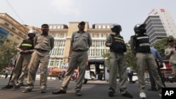 Cambodian police officers stand guard in front of the Phnom Penh Municipal Court, in Phnom Penh, Cambodia, Thursday, Jan. 16, 2020. (AP Photo)