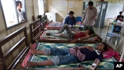 FILE - Patients with malaria areg treated at the hospital in Pailin, Cambodia, Aug. 26, 2009.