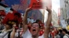 FILE - A demonstrator holds up a sign during a protest to demand authorities scrap a proposed extradition bill with China, in Hong Kong, China June 9, 2019.