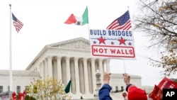 People rally outside the Supreme Court, Nov. 12, 2019, in Washington.