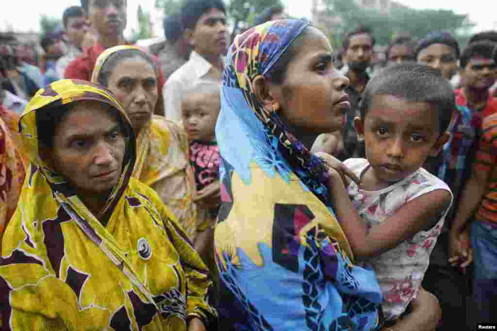 Relatives of garment workers gather in front of a factory after a fire, Dhaka, Bangladesh, May 9, 2013.