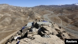 FILE - The ruins of an ancient temple in Mes Aynak, Logar province, Afghanistan, are seen in this Feb. 14, 2015, photo. The copper lying beneath the ancient Buddhist ruins is one of the world's largest untapped deposits.