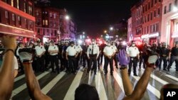 Protesters take a knee on Flatbush Avenue in front of New York City police officers during a solidarity rally for George Floyd, Thursday, June 4, 2020, in the Brooklyn borough of New York. Floyd died after being restrained by Minneapolis police…