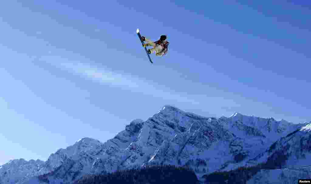 U.S. snowboarder Ryan Stassel takes air off a jump during slopestyle snowboard training at the 2014 Sochi Winter Olympics, Feb. 4, 2014.
