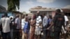 FILE - People wait in line to vote at a polling station in Accra, Ghana, Dec. 8, 2012.