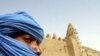 A Tuareg nomad stands near the 13th century mosque at Timbuktu, Mali (file photo).