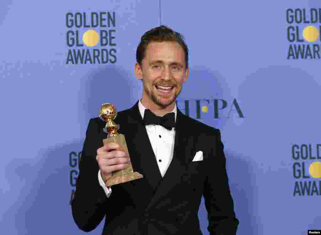 Actor Tom Hiddleston holds the award for Best Performance by an Actor in a Limited Series or a Motion Picture Made for Television for his role in "The Night Manager" during the 74th Annual Golden Globe Awards in Beverly Hills, CA, Jan. 8, 2017.