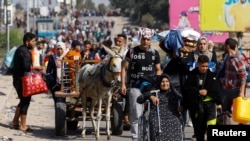 Palestinians fleeing north Gaza move southward, in the central Gaza Strip