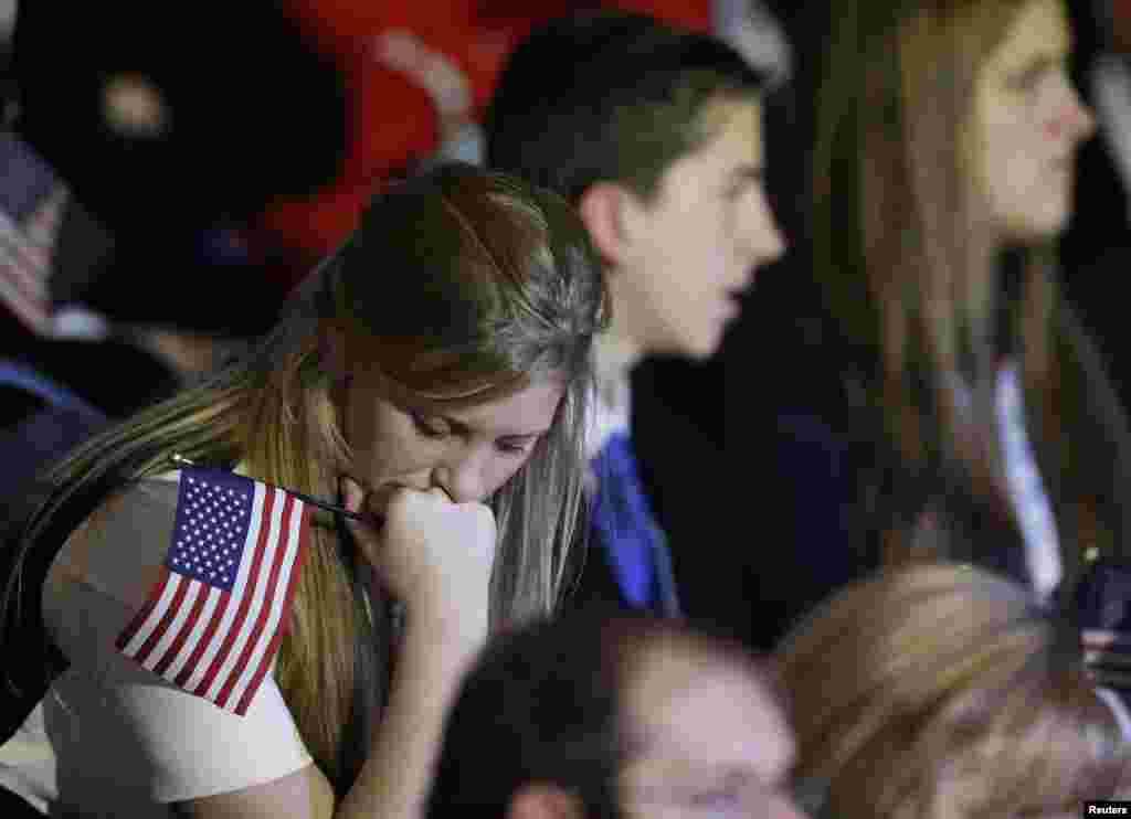 A supporter reacts to voting results displayed on a TV screen during Republican presidential candidate Mitt Romney's election night rally in Boston, Massachusetts, November 7, 2012.