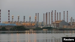 FILE - A view of the Abadan oil refinery in southwest Iran, from the Iraqi side of the Shatt al-Arab waterway, south of Basra, Sept. 21, 2019.
