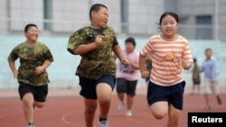 FILE - Children exercise during a weight-losing summer camp in Shenyang, Liaoning province, China.
