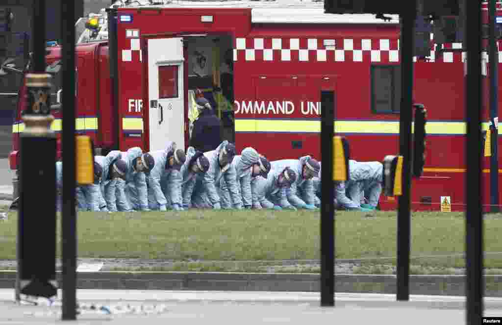 Police officers search an area of Parliament Square the morning after an attack in London, Britain, March 23, 2017.