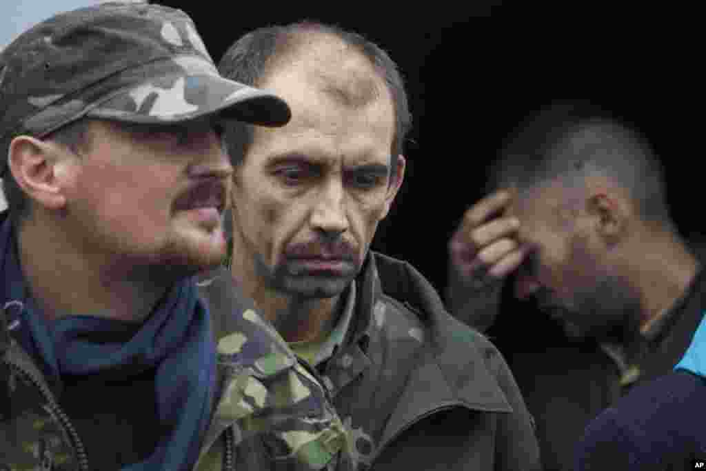 Ukrainian Prisoners of War stand in the backyard of a government building in the town of Illovaysk, eastern Ukraine, Oct. 16, 2014.