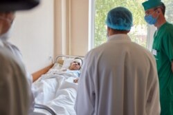 Ukrainian President Volodymyr Zelenskiy visits a military hospital to meet with cadet Vyacheslav Zolochevskyi, who survived the crash of the Antonov An-26 aircraft, in Kharkiv, Ukraine, Sept. 26, 2020. (Presidential Press Service via Reuters)