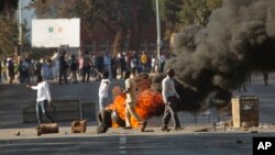 Zimbabweans protest in downtown Harare, Zimbabwe, Wednesday Aug. 1, 2018. Zimbabwe's electoral commission said it would say "sometime tomorrow" when it can start announcing the results of the race pitting President Emmerson Mnangagwa and Nelson Chamisa of the MDC Alliance.