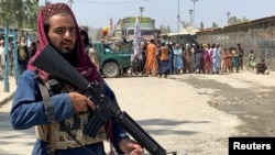A member of the Taliban forces stands guard at the Pakistan-Afghanistan crossing border, in Torkham, Pakistan, September 2, 2021. 