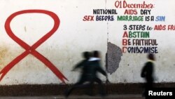 Children run past a mural painting of an Aids ribbon at a school in Khutsong Township, 74 km (46 miles) west of Johannesburg, August 22, 2011. 