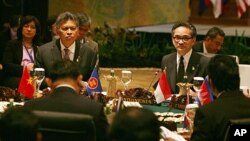 ASEAN Secretary General Surin Pitsuwan, left, and Indonesia's Foreign Minister Marty Natalegawa attend the ASEAN Ministerial meeting in Nusa Dua, Bali, Indonesia, July 19, 2011
