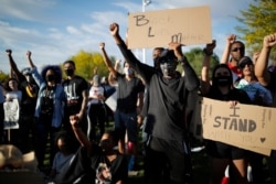 Protesters hold their fists in the air during a rally in Las Vegas against police brutality sparked by the death of George Floyd,June 5, 2020.