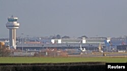 FILE - A police vehicle stands on the closed runway at Gatwick Airport after drones flying illegally over the airfield forced the closure of the airport, in Gatwick, Britain, Dec. 20, 2018. 