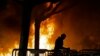 FILE - In this Feb. 1, 2017, photo, a fire set by demonstrators protesting a scheduled speaking appearance by Breitbart News editor Milo Yiannopoulos burns on Sproul Plaza on the University of California, Berkeley campus.