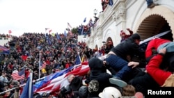 FILE - Pro-Trump protesters storm into the U.S. Capitol during a rally to contest the certification of the 2020 U.S. presidential election results by the U.S. Congress, in Washington, Jan. 6, 2021.