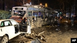 FILE - Damaged vehicles are seen at the scene of an explosion in Ankara, Turkey, Sunday, March 13, 2016.