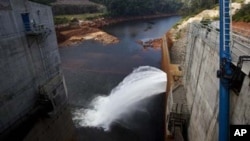In this photo taken on Oct. 24, 2010, the Nam Theun 2 dam on the Nam Theun river, a tributary of the Mekong river, in central Laos releases water to the river below.