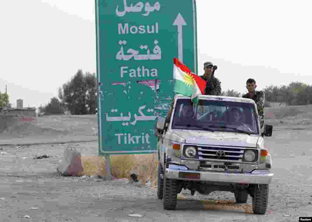 Members of the Kurdish security forces take part in an intensive security deployment on the outskirts of Kirkuk, June 12, 2014. 