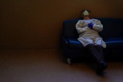 FILE - Dr. Mher Onanyan rests while waiting for an X-ray of a COVID-19 patient's lungs at Providence Holy Cross Medical Center in the Mission Hills section of Los Angeles, Dec. 22, 2020.